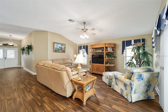 living room with ceiling fan, dark hardwood / wood-style flooring, a textured ceiling, and vaulted ceiling