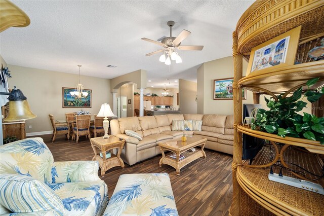 living room featuring ceiling fan, dark hardwood / wood-style flooring, and a textured ceiling