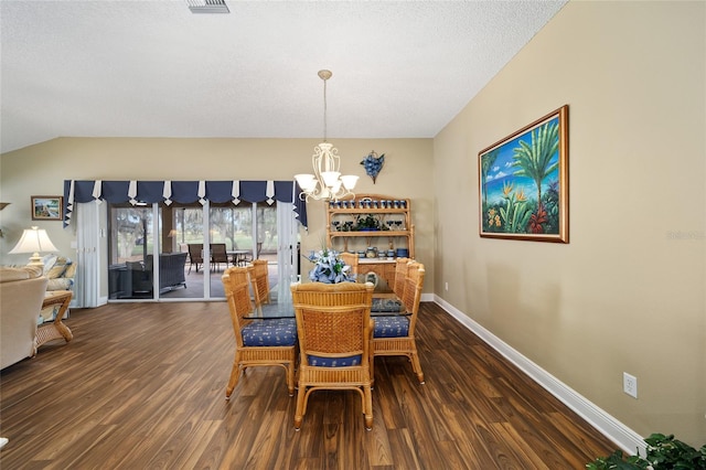 dining space with a textured ceiling, vaulted ceiling, dark wood-type flooring, and an inviting chandelier