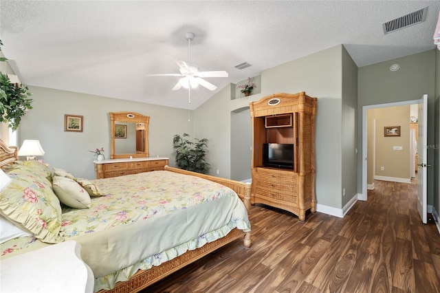 bedroom with lofted ceiling, ceiling fan, dark hardwood / wood-style flooring, and a textured ceiling