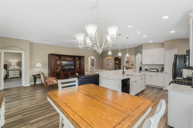 dining area with a chandelier, dark hardwood / wood-style flooring, and sink