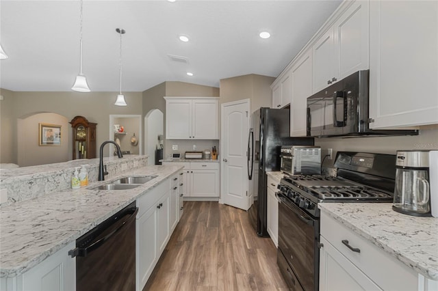 kitchen featuring lofted ceiling, black appliances, sink, dark hardwood / wood-style floors, and white cabinetry