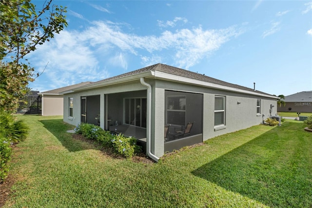 view of side of home featuring a lawn and a sunroom