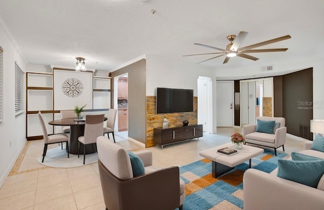 tiled living room featuring ceiling fan and crown molding