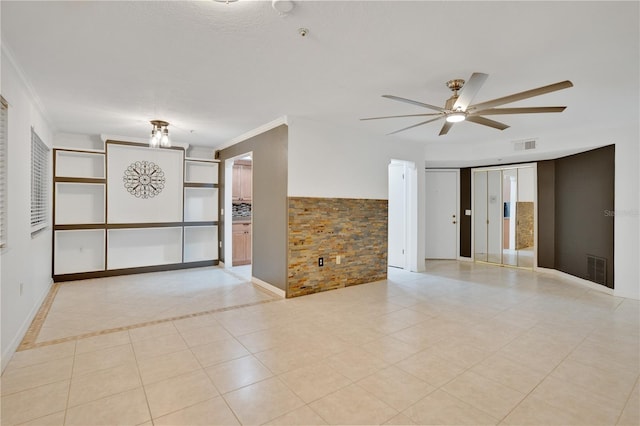 tiled spare room featuring ceiling fan, brick wall, and ornamental molding