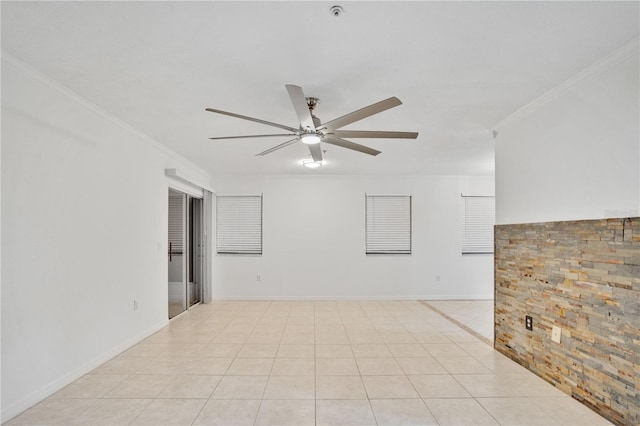 unfurnished room with crown molding, light tile patterned flooring, and ceiling fan