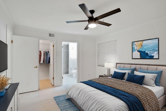 bedroom featuring a walk in closet, ensuite bath, ornamental molding, ceiling fan, and a closet