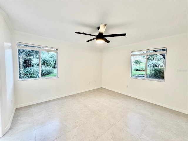 spare room featuring a wealth of natural light and ceiling fan