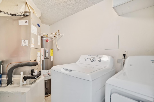 washroom featuring separate washer and dryer, water heater, heating unit, and a textured ceiling