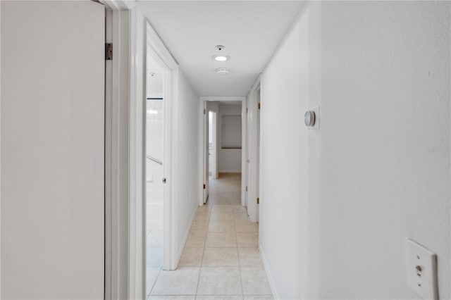 hall featuring light tile patterned floors