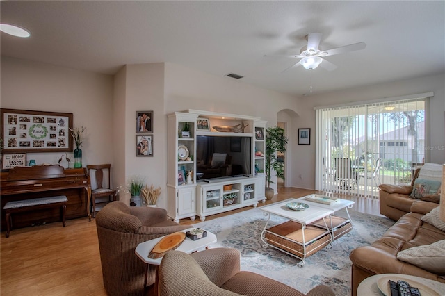 living room with ceiling fan and light hardwood / wood-style flooring