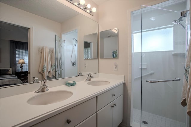 bathroom featuring vanity, a shower with shower door, and a textured ceiling