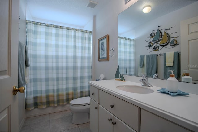 full bathroom with shower / tub combo, vanity, a textured ceiling, tile patterned flooring, and toilet