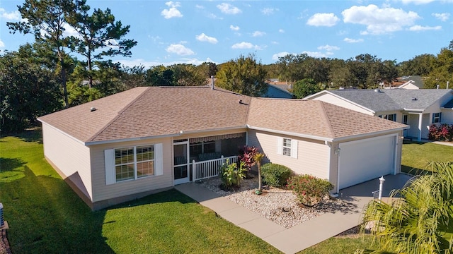 rear view of property featuring a lawn, a porch, and a garage