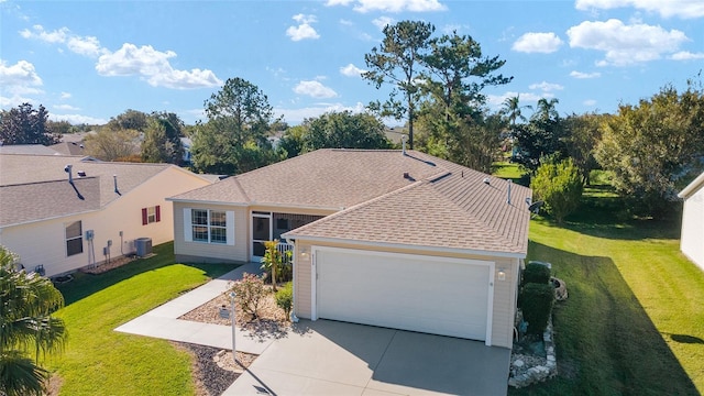 ranch-style house featuring a front lawn, cooling unit, and a garage