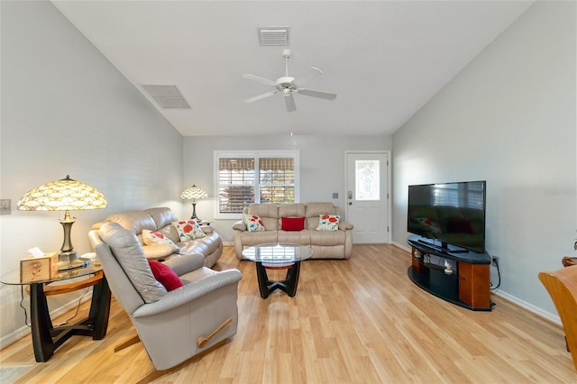 living room featuring ceiling fan, lofted ceiling, and light wood-type flooring