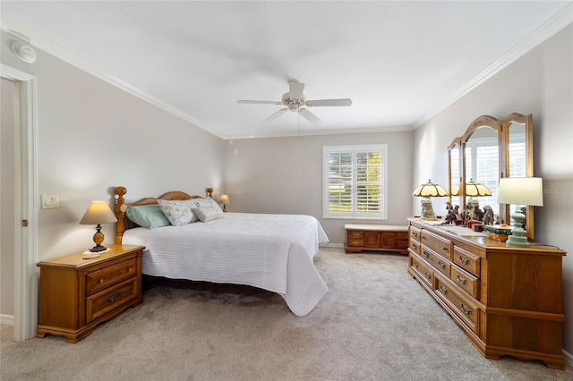 bedroom featuring ceiling fan, ornamental molding, and light carpet