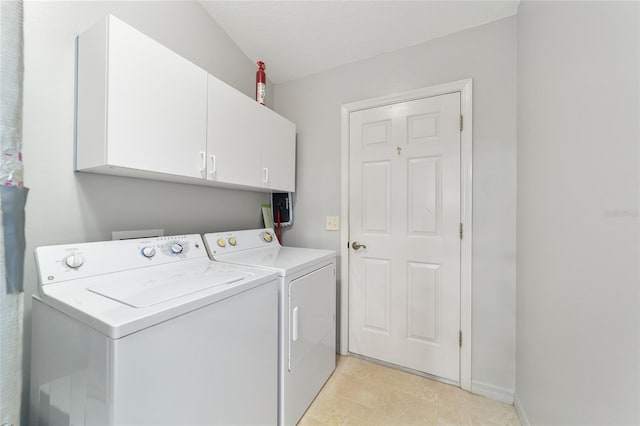 laundry room featuring washing machine and dryer and cabinets