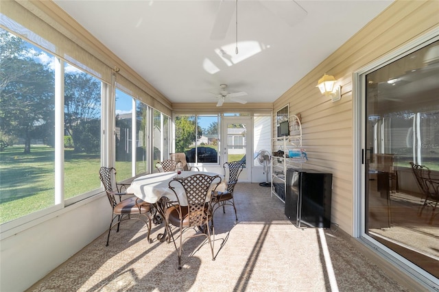 sunroom / solarium featuring ceiling fan