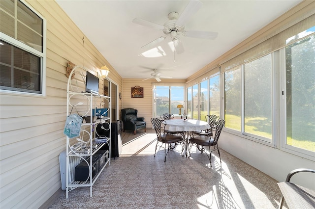 sunroom with plenty of natural light and ceiling fan