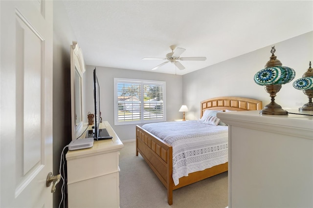 bedroom featuring ceiling fan and light colored carpet