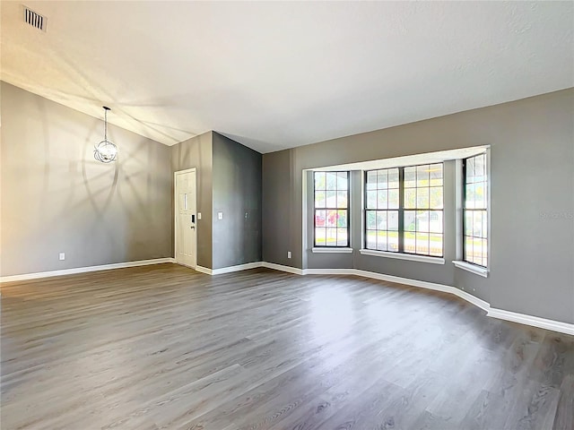 empty room with hardwood / wood-style flooring