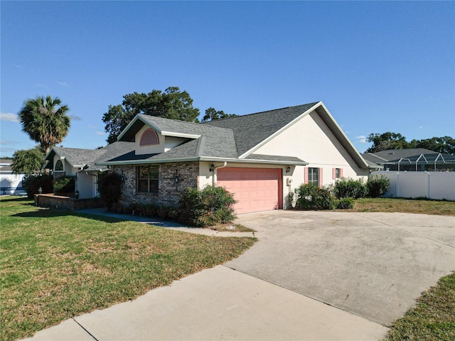 view of front of home with a garage and a front lawn