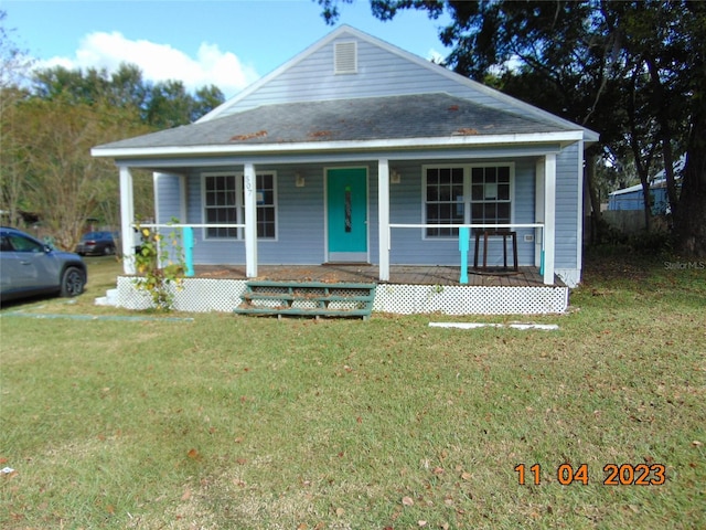 view of front of house with a porch and a front lawn