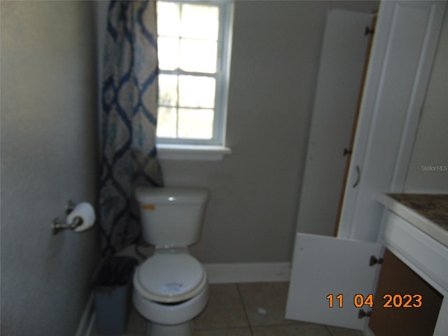 bathroom with tile patterned flooring, vanity, and toilet