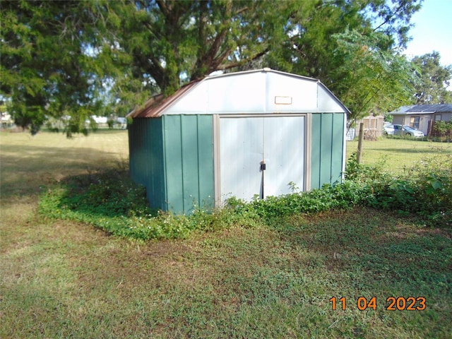 view of outbuilding featuring a yard