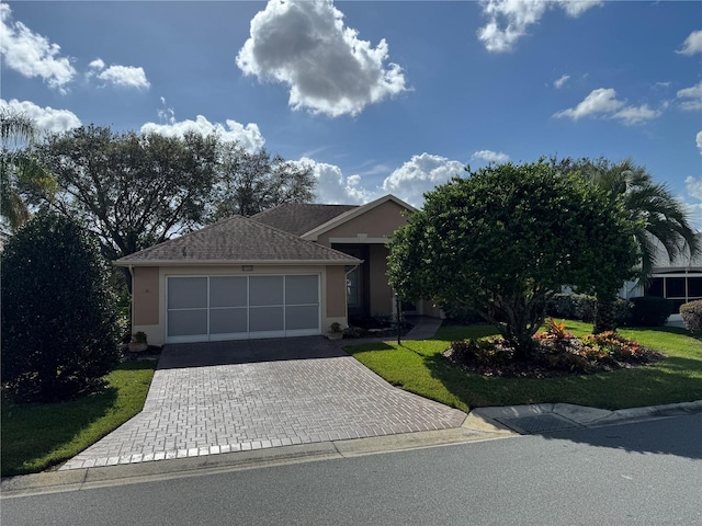 view of front of home featuring a garage and a front yard