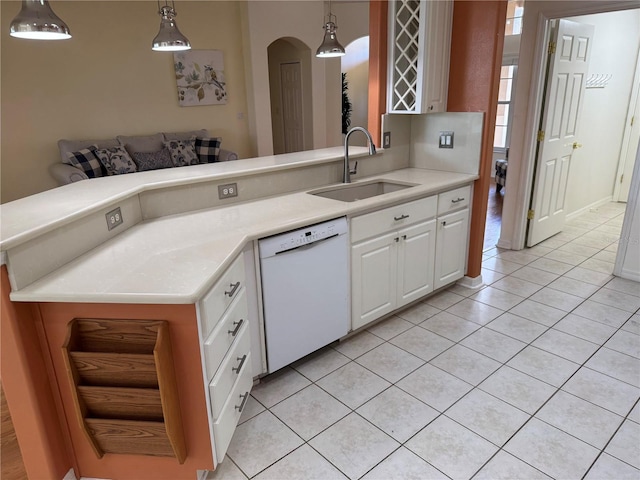 kitchen with white cabinetry, sink, white dishwasher, decorative light fixtures, and light tile patterned flooring