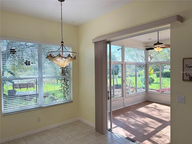 unfurnished dining area with tile patterned flooring and ceiling fan