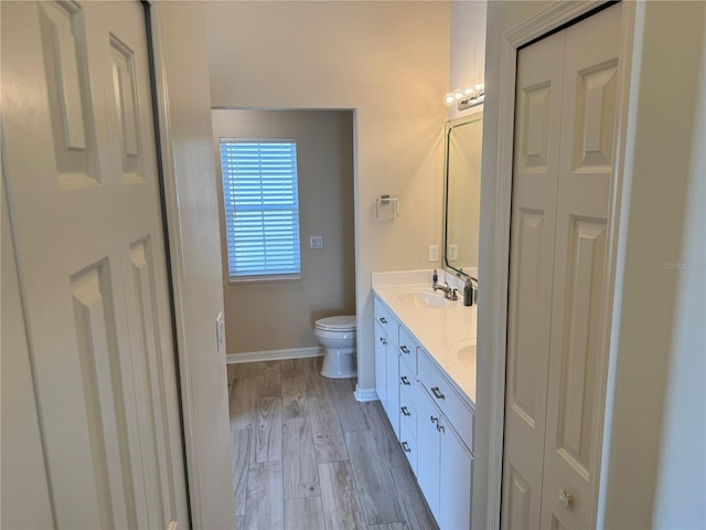 bathroom featuring hardwood / wood-style floors, vanity, and toilet