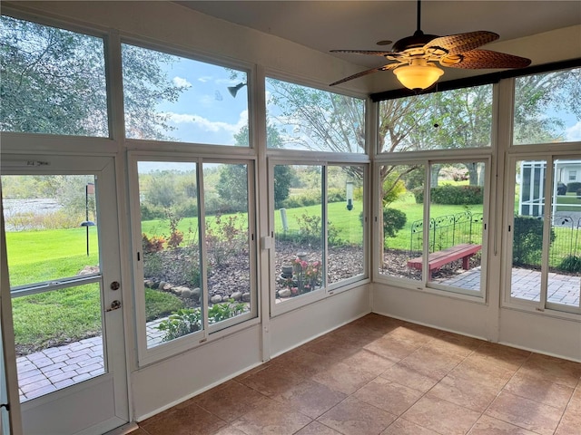 unfurnished sunroom featuring plenty of natural light and ceiling fan