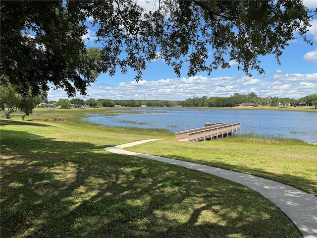 dock area featuring a yard and a water view