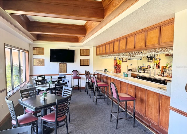 interior space featuring dark colored carpet and a tray ceiling