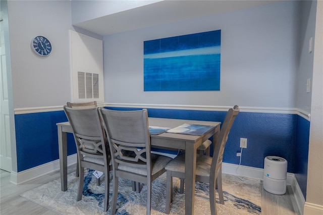 3406 Soho St Unit 102, Orlando, FL 32835 - dining area featuring baseboards and wood finished floors