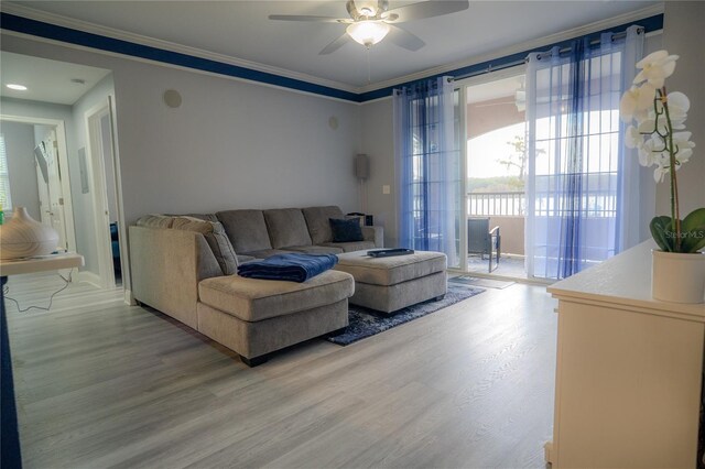 3406 Soho St Unit 102, Orlando, FL 32835 - living area featuring light wood-style flooring, ceiling fan, and crown molding