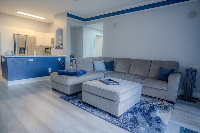 3406 Soho St Unit 102, Orlando, FL 32835 - living area featuring light wood-style flooring and crown molding