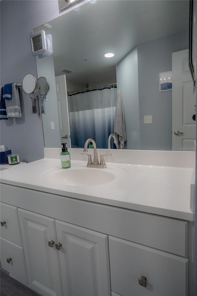 bathroom with a shower with curtain and vanity