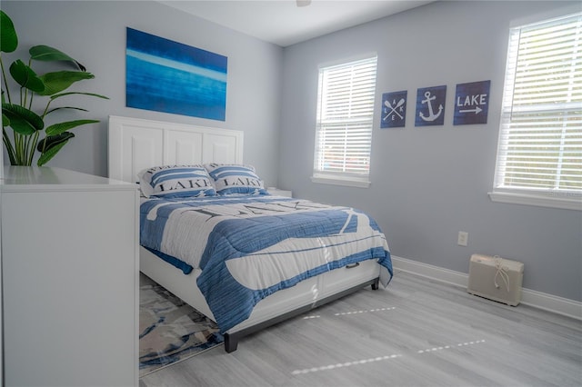 3406 Soho St Unit 102, Orlando, FL 32835 - bedroom featuring baseboards and wood finished floors