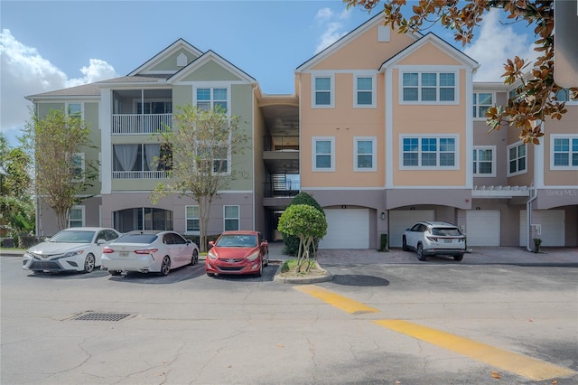 3406 Soho St Unit 102, Orlando, FL 32835 - view of building exterior with an attached garage