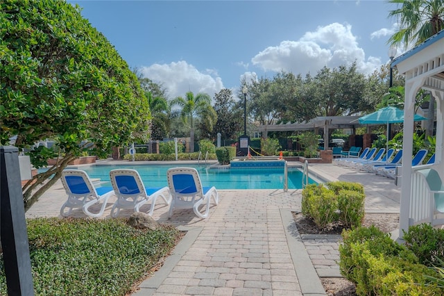 view of pool with a pergola and a patio area