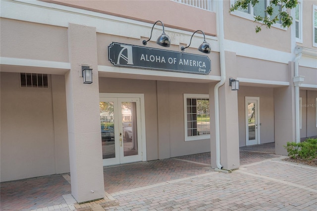 3406 Soho St Unit 102, Orlando, FL 32835 - doorway to property with french doors and stucco siding