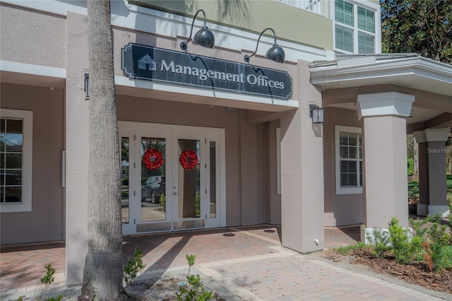 3406 Soho St Unit 102, Orlando, FL 32835 - view of exterior entry featuring stucco siding and french doors