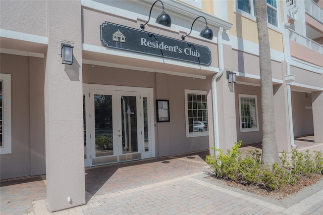 view of exterior entry featuring french doors