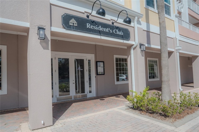 3406 Soho St Unit 102, Orlando, FL 32835 - property entrance with french doors and stucco siding