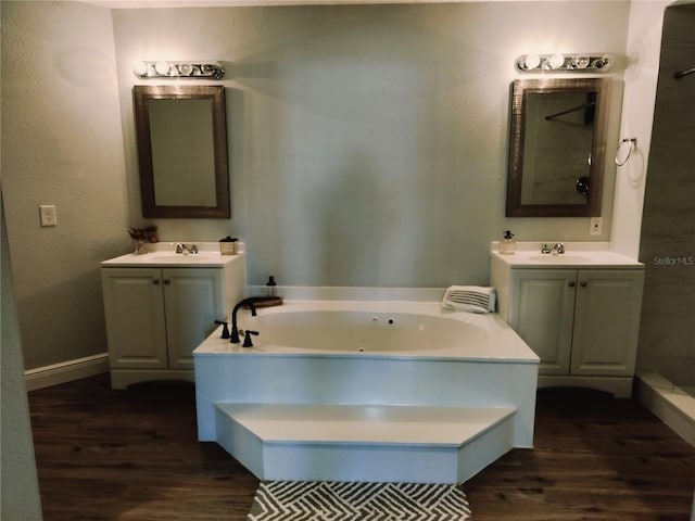 bathroom featuring a washtub, vanity, and hardwood / wood-style flooring