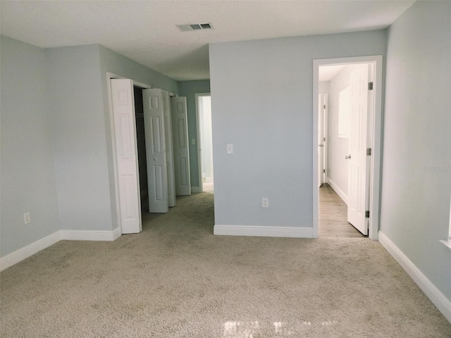 unfurnished bedroom with light carpet